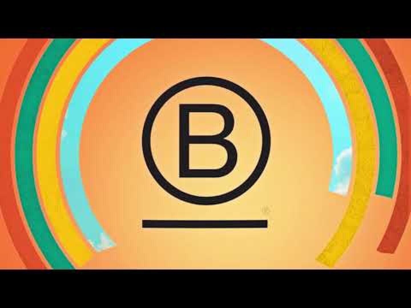 Der Buchstabe B in Fettdruck innerhalb eines Kreises mit einer horizontalen Linie darunter, umgeben von farbigen halbkreisförmigen Bögen auf einem orangefarbenen Hintergrund.