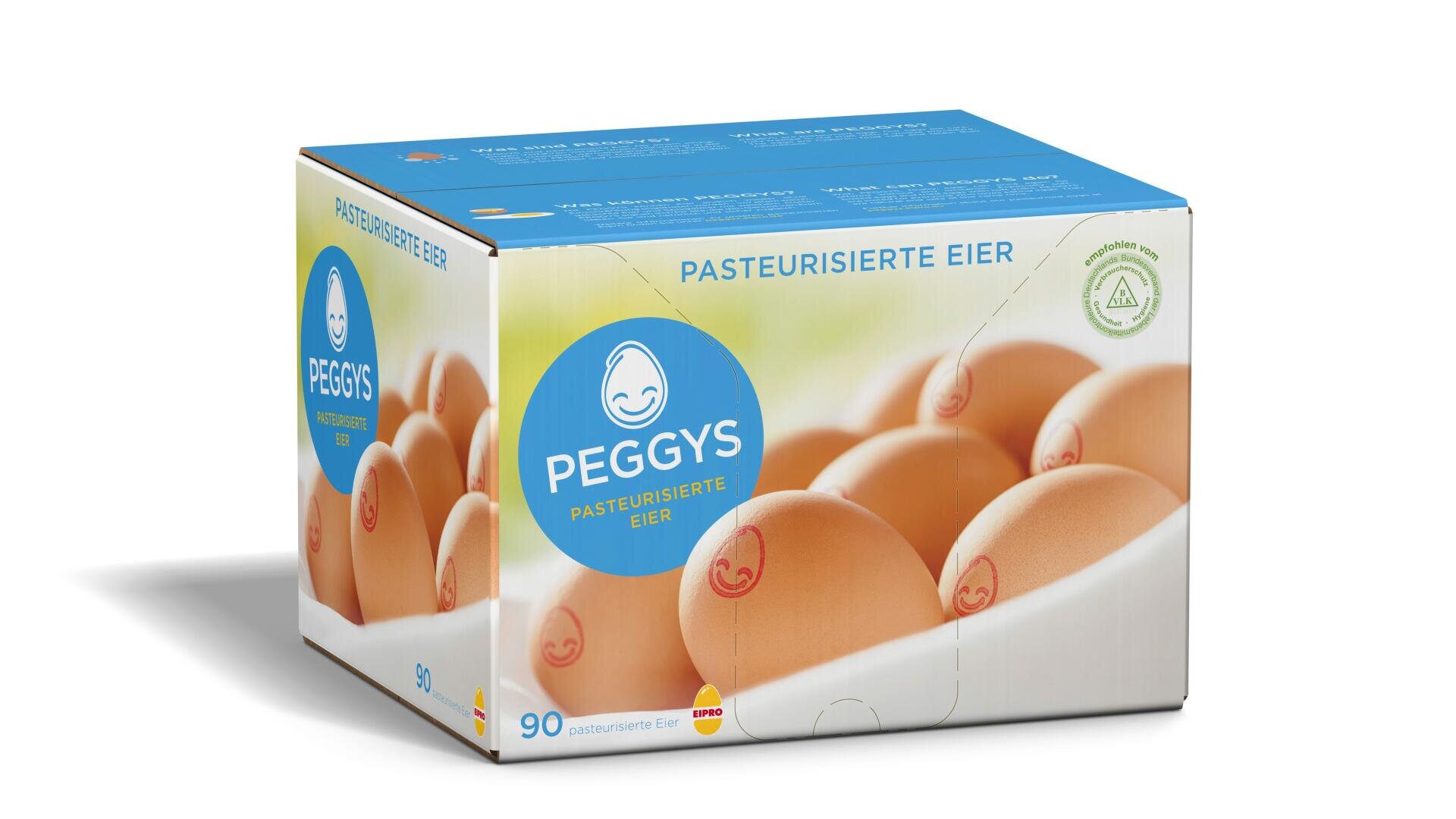 Une boîte bleue et blanche étiquetée PEGGYS PASTEURISIERTE EIER montre une image d'œufs bruns. La boîte contient 90 œufs pasteurisés et comporte un simple logo d'œuf souriant. Le texte est en allemand.