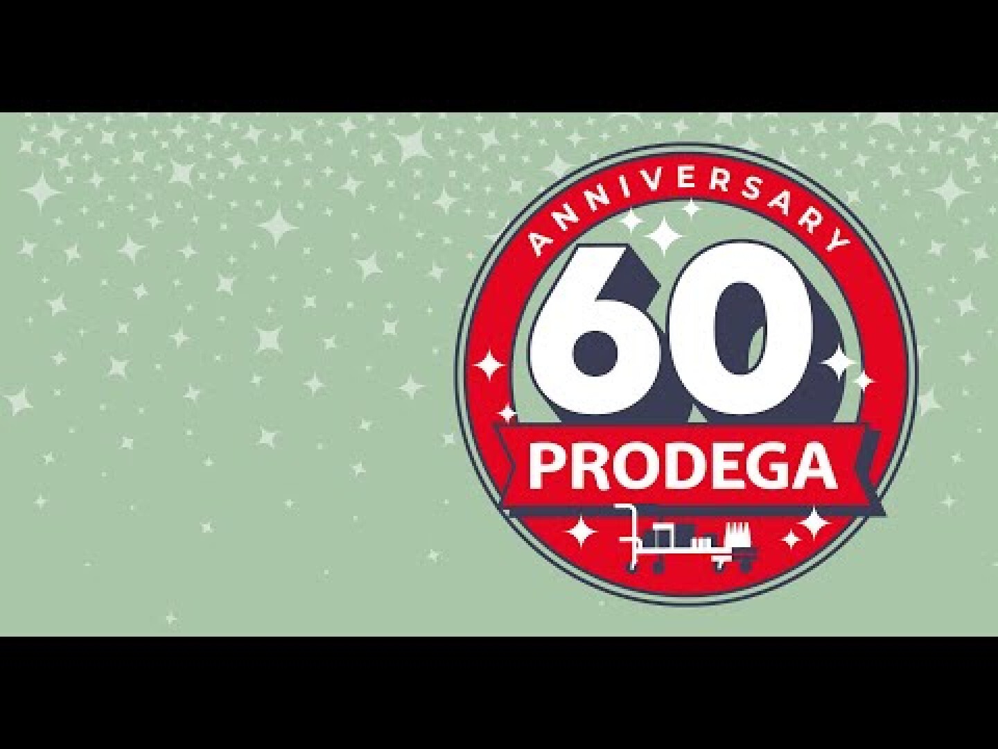 Ein rot-weißes, kreisförmiges Emblem trägt die Aufschrift „60 Anniversary PRODEGA“ auf grünem Hintergrund mit weißen Sternen. Am unteren Rand des Emblems ist der Umriss eines Gebäudes zu sehen.